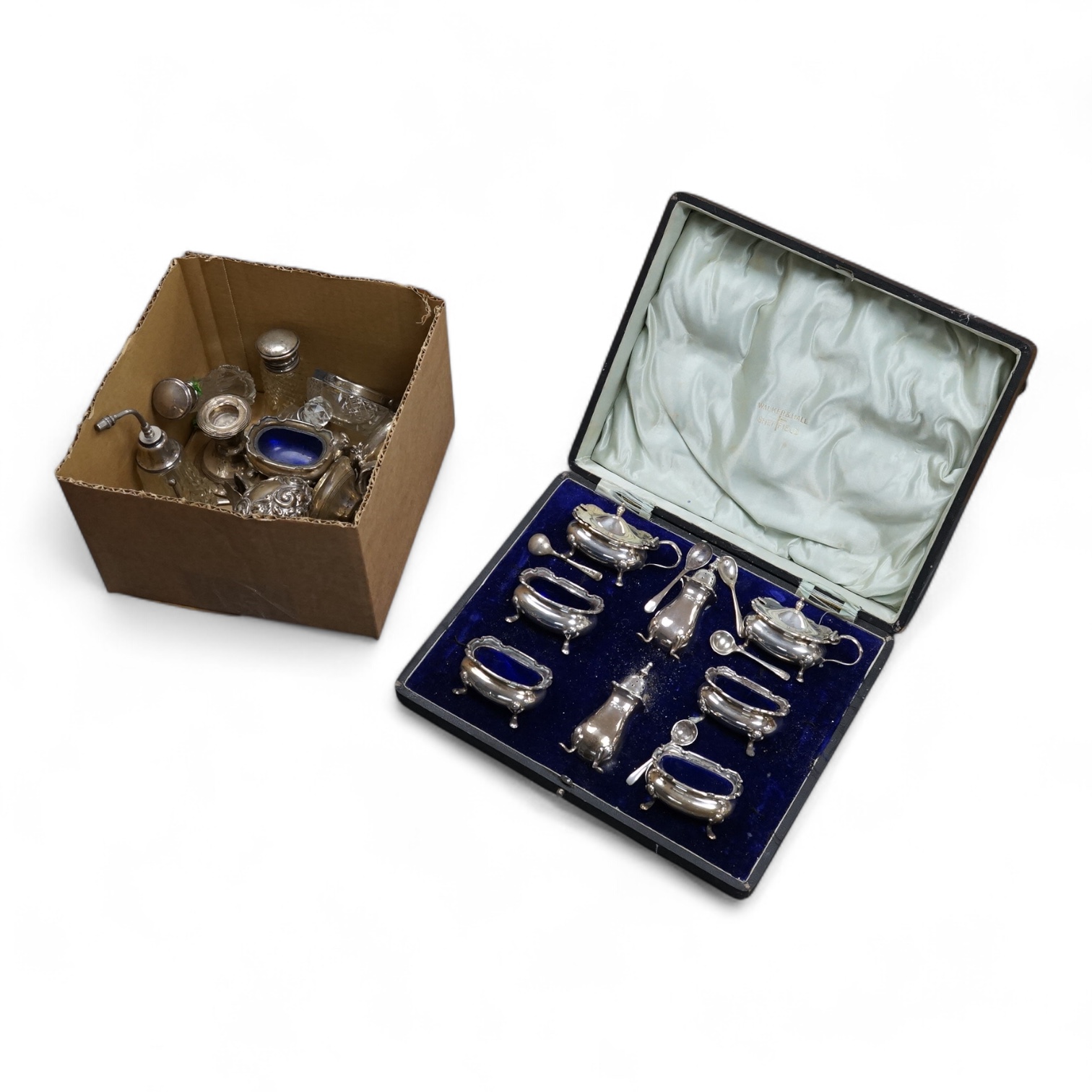 A George V cased eight piece silver condiment set, by Walker and Hall, Sheffield, 1912/1913, together with a group of assorted silver condiments and silver mounted toilet jars, etc.